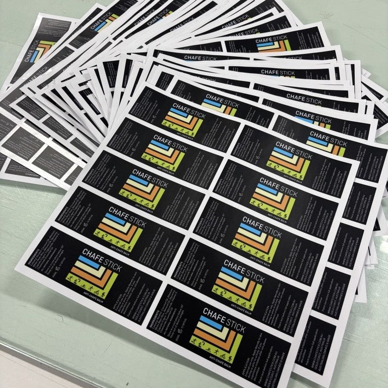 Stack of Chafe Stick labels on a light gray surface
