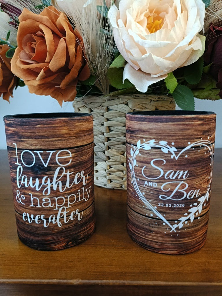 Two wooden vases with engraved text and floral arrangement in the background
