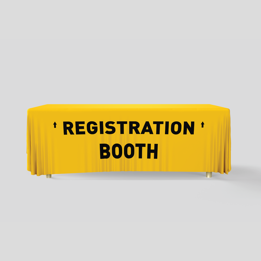 Yellow tablecloth with 'REGISTRATION BOOTH' text on a gray background